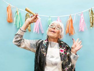 a happy elderly woman celebrating her birthday